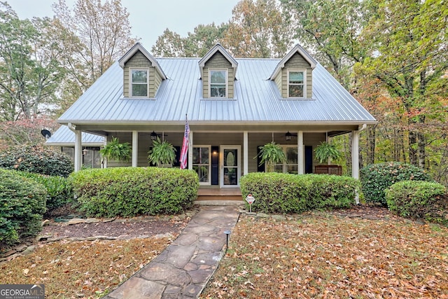 view of home's exterior featuring ceiling fan, metal roof, and a sunroom