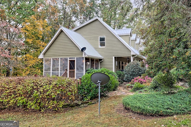 view of front of property with a sunroom and metal roof