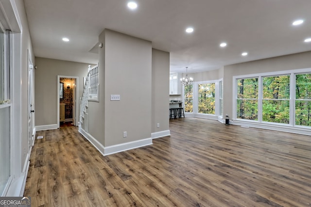 interior space with stairs, dark wood finished floors, a notable chandelier, and recessed lighting