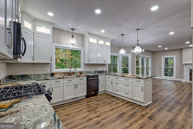 kitchen with hanging light fixtures and white cabinetry