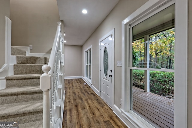 entrance foyer featuring recessed lighting, stairway, baseboards, and wood finished floors