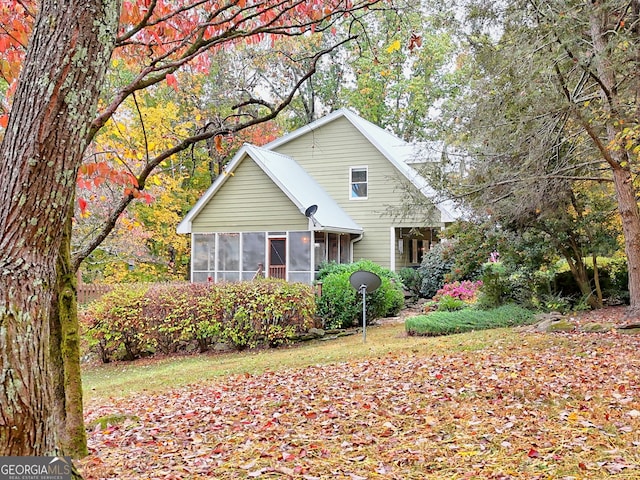 view of front of home featuring a sunroom