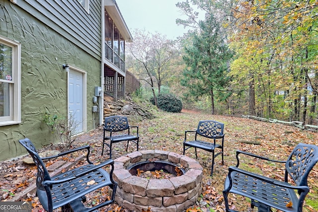 view of patio with a fire pit and a sunroom