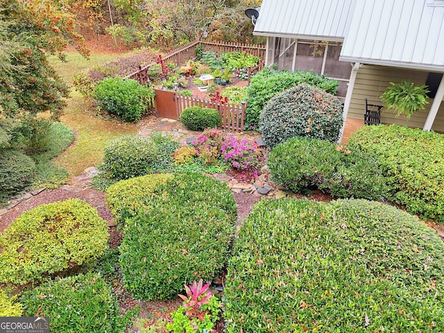 view of yard with fence and a sunroom