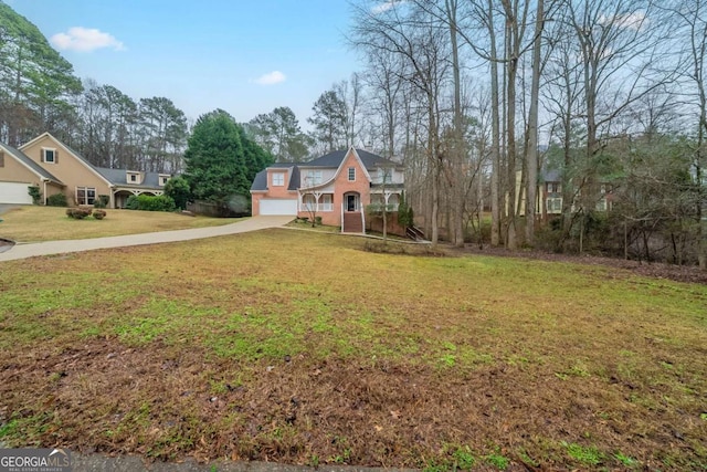 view of front of home featuring concrete driveway and a front yard