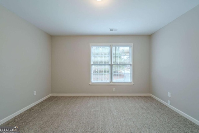 4570 Thicket Trl, Snellville, GA 30039 - spare room featuring carpet flooring and baseboards
