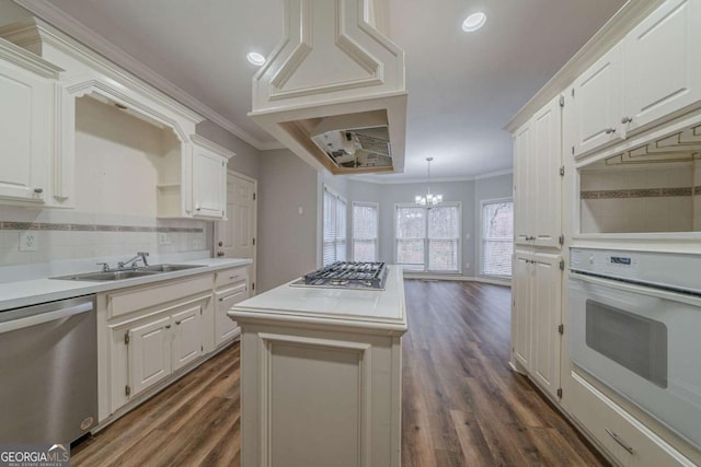 kitchen featuring light countertops, appliances with stainless steel finishes, a sink, and white cabinetry