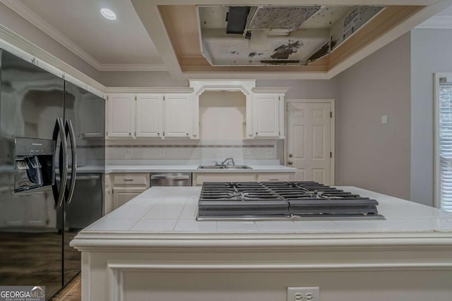 4570 Thicket Trl, Snellville, GA 30039 - kitchen featuring stainless steel appliances, tile countertops, a center island, ornamental molding, and decorative backsplash