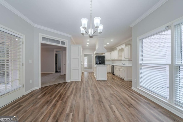 4570 Thicket Trl, Snellville, GA 30039 - kitchen featuring black refrigerator with ice dispenser, island range hood, stainless steel dishwasher, wood finished floors, and crown molding