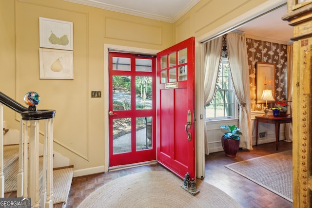 doorway to outside with stairway, dark wood finished floors, crown molding, and a decorative wall