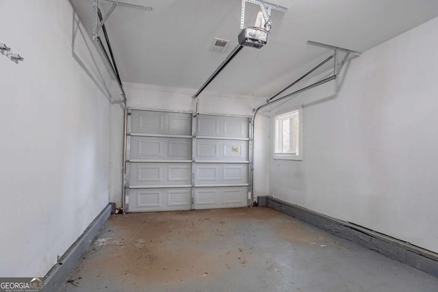 garage featuring a garage door opener and baseboards