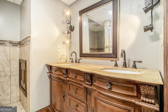 full bathroom with double vanity and a sink