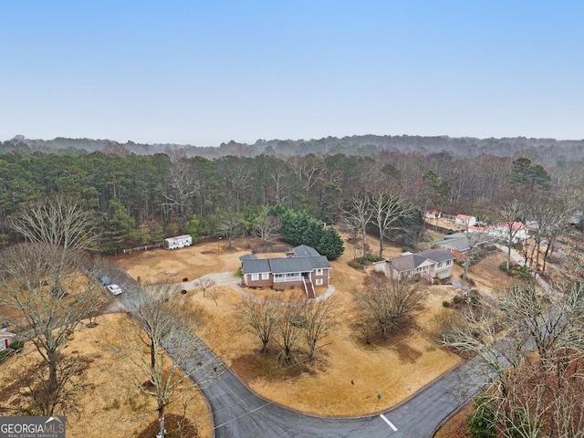 drone / aerial view featuring a view of trees