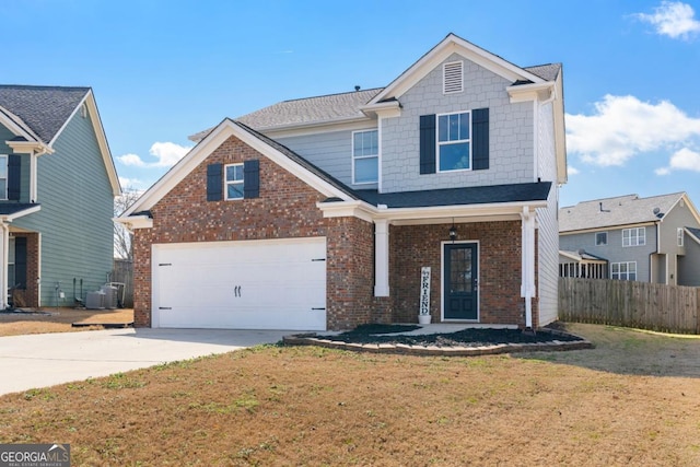 view of front of house featuring driveway, fence, a front lawn, and brick siding