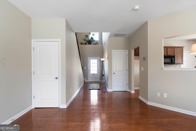 entrance foyer featuring visible vents, baseboards, and dark wood-style flooring