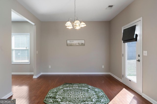 interior space featuring dark wood-type flooring, visible vents, and baseboards