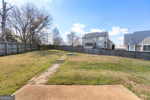 view of yard with a fenced backyard