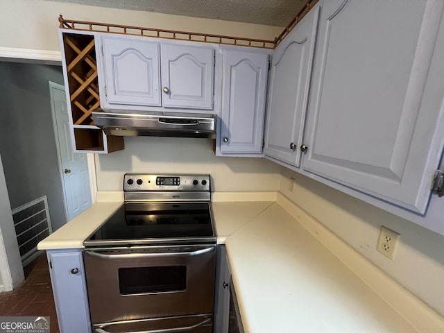 kitchen with under cabinet range hood, white cabinetry, stainless steel electric stove, and light countertops