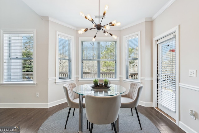 dining space with ornamental molding, baseboards, an inviting chandelier, and wood finished floors