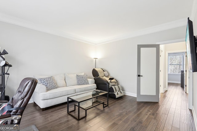 living area with dark wood finished floors, baseboards, and ornamental molding