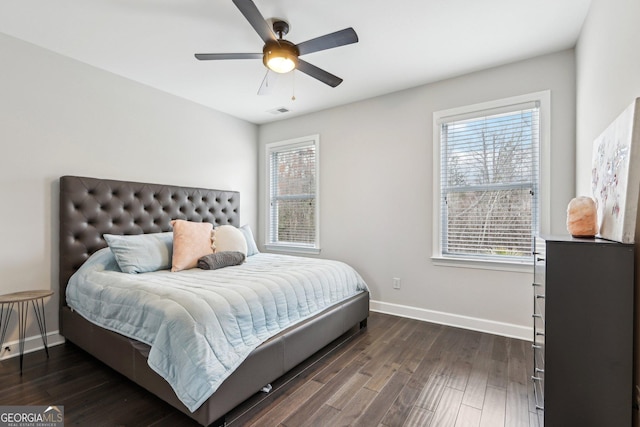 bedroom with dark wood finished floors, visible vents, baseboards, and a ceiling fan