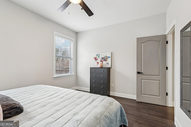 bedroom featuring baseboards, dark wood finished floors, and a ceiling fan