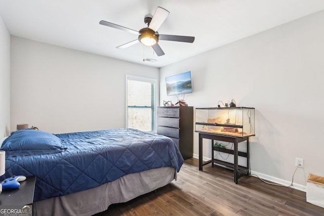 bedroom with ceiling fan, visible vents, baseboards, and dark wood-style floors