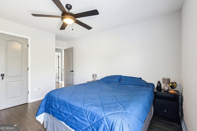 bedroom featuring a ceiling fan, wood finished floors, and baseboards