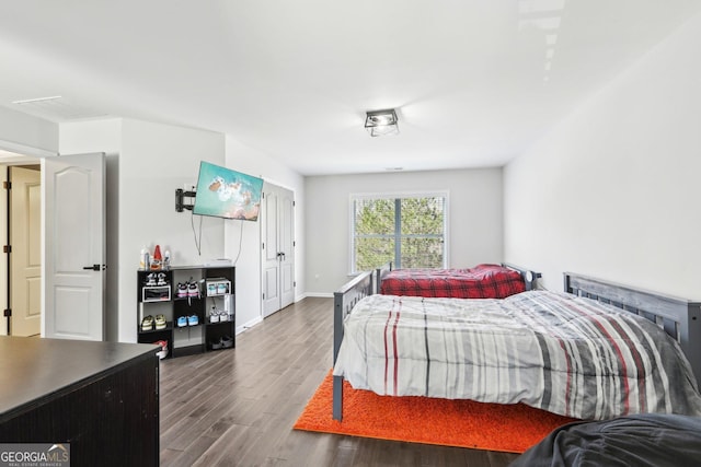 bedroom featuring baseboards and wood finished floors