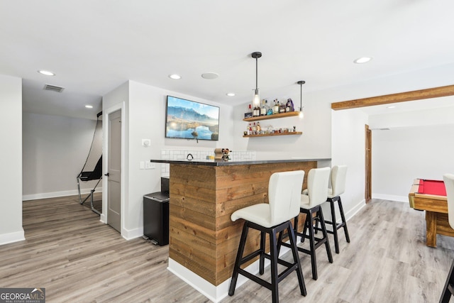 bar featuring recessed lighting, a dry bar, and light wood-type flooring