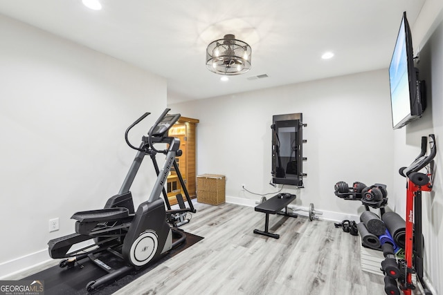 workout room featuring visible vents, recessed lighting, wood finished floors, and baseboards