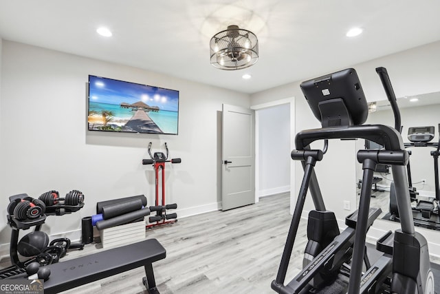 exercise room featuring a notable chandelier, recessed lighting, light wood-type flooring, and baseboards