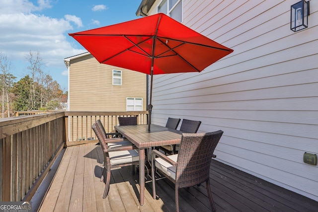 wooden deck featuring outdoor dining space