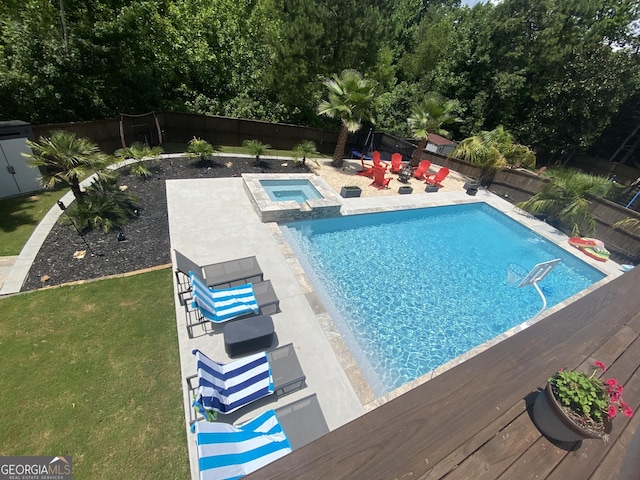 view of pool featuring a lawn, an in ground hot tub, a fenced backyard, and a fenced in pool