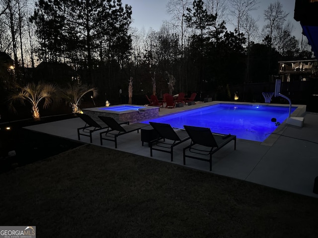 pool featuring an in ground hot tub and a patio