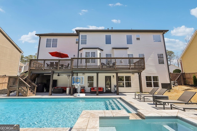 rear view of property featuring a patio area, a wooden deck, stairs, and fence