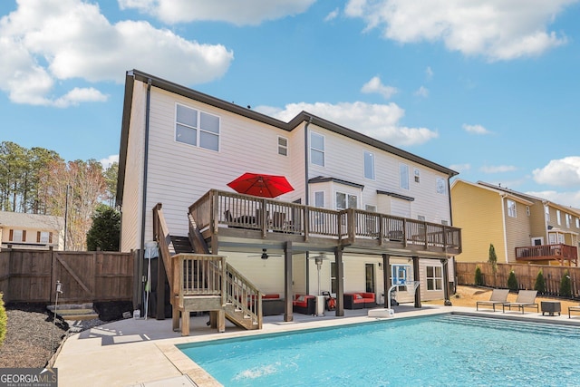 rear view of property with fence, stairs, a deck, a patio area, and a gate