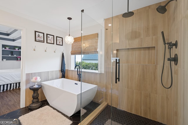 full bath with a stall shower, a freestanding bath, crown molding, and a wainscoted wall