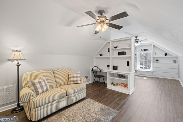 living area with lofted ceiling, wood finished floors, and visible vents