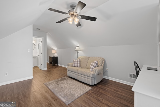 living room with baseboards, visible vents, and wood finished floors