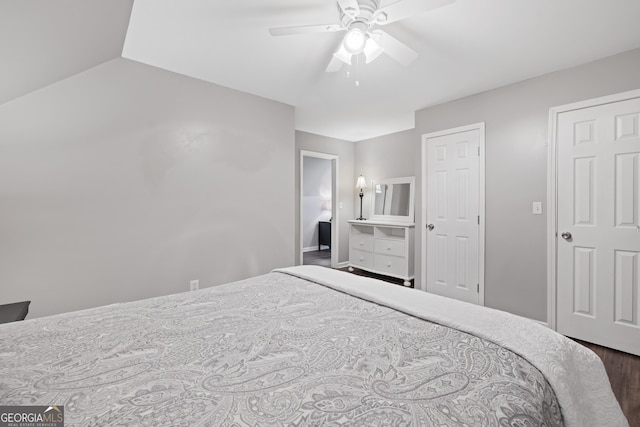 bedroom with lofted ceiling, a ceiling fan, and wood finished floors