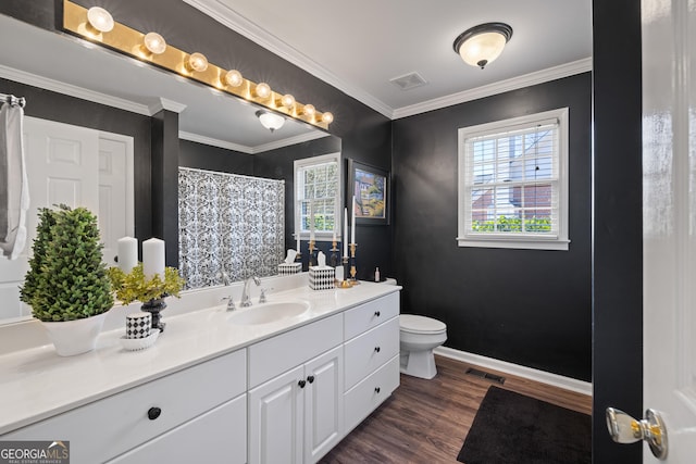 full bath with ornamental molding, visible vents, and wood finished floors