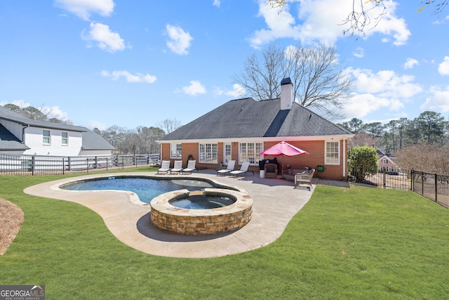 back of property featuring a fenced backyard, a patio, brick siding, and a lawn