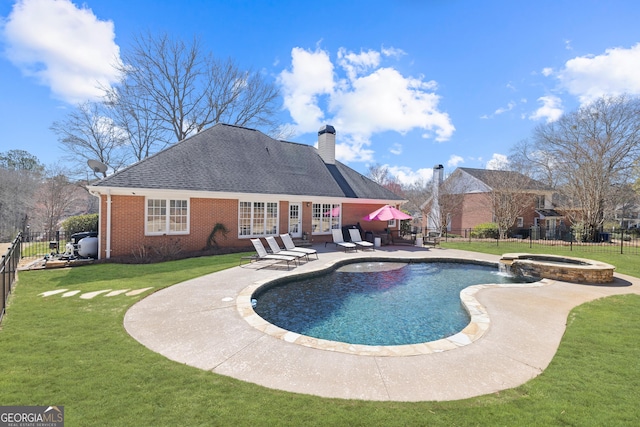 view of swimming pool featuring a pool with connected hot tub, a patio area, a fenced backyard, and a yard