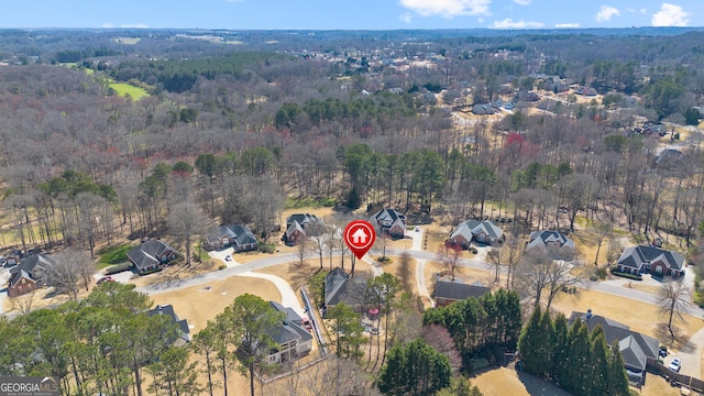 birds eye view of property with a view of trees