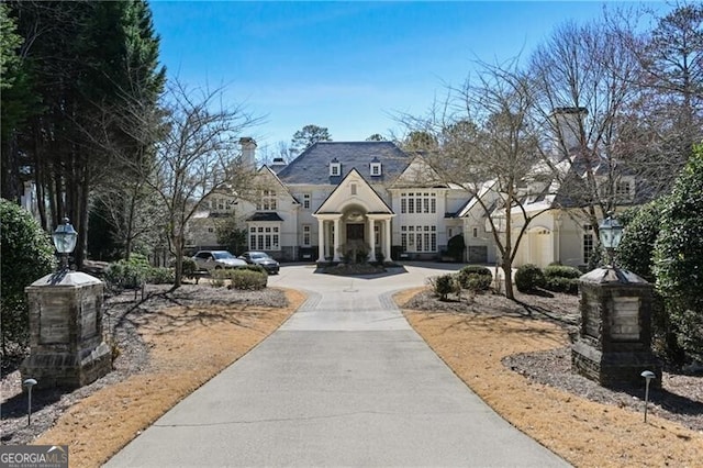 french country inspired facade with driveway