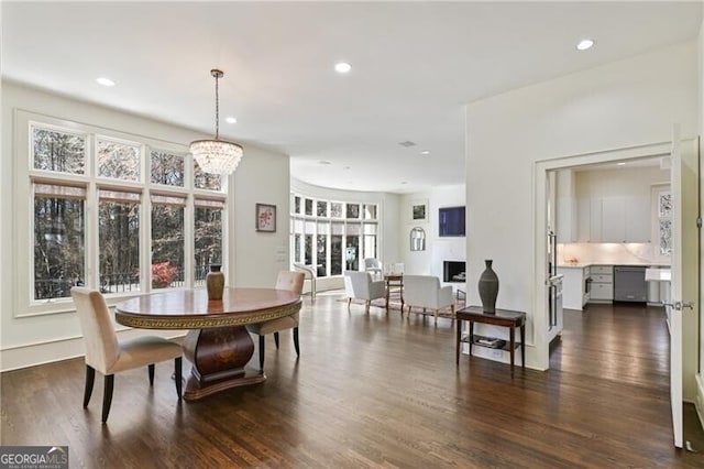 dining room with an inviting chandelier, dark wood-type flooring, and recessed lighting