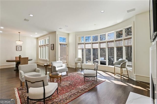 living area featuring visible vents, wood finished floors, a wealth of natural light, and recessed lighting