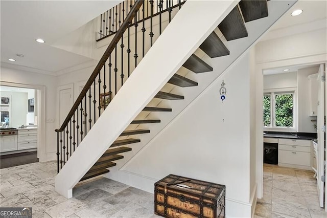 stairway with recessed lighting and crown molding