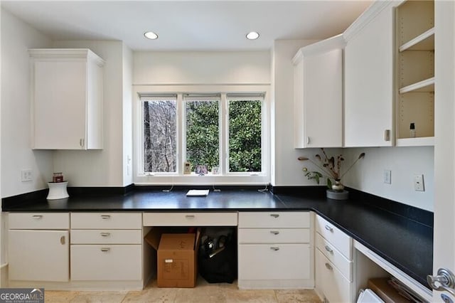 kitchen featuring dark countertops, white cabinets, and recessed lighting